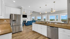 Una cocina moderna con electrodomésticos de acero inoxidable, armarios blancos y una isla grande.