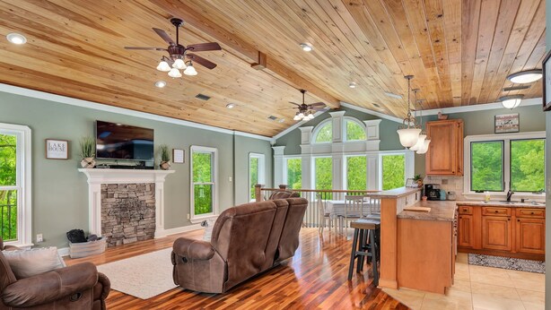 A spacious living room with a fireplace, two sofas, and a TV. - Spacious 5 bedroom house with double decker dock on quiet lakefront! (Arley)