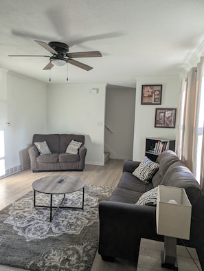 A living room with a ceiling fan, two sofas, a coffee table, and a bookshelf. - The Cozy Retreat
Comfort, Fun & Convenience
(Windsor Heights)