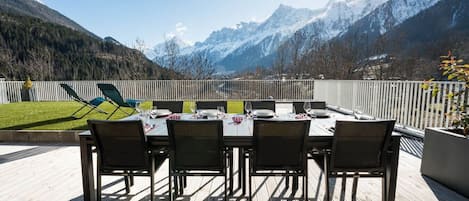 An outdoor dining area with a view of snow-capped mountains.