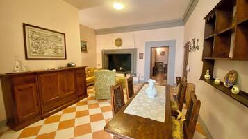 Un comedor con suelo a cuadros, muebles de madera y una chimenea.