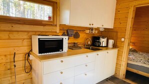 A compact kitchen with a microwave, coffee maker, and sink. - 4 Person Holiday Home in Yngsjo (Yngsjo)