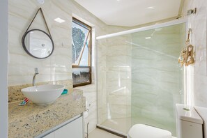 A bathroom with a white sink, a mirror, a glass shower enclosure, and a toilet. - VT08 Great Apt for 3 people - Beachfront Cond. (Lauro de Freitas)