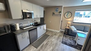 A modern kitchen with a microwave, coffee maker, and dishwasher. - Private Ptarmigan Suite (Hayden)