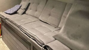 A vehicle interior with a cushioned bench seat, a window, and a door. - Renovated Apartment High Standard to City Center, Park (Tromsø)