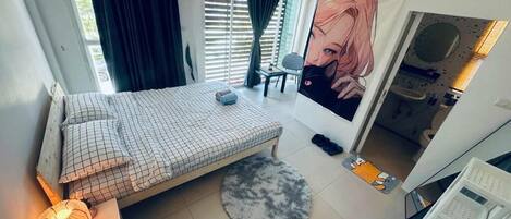 A bedroom with a bed, a desk, a chair, a window with curtains, a poster, and a radiator.