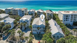 A coastal hotel complex with multiple buildings, a central staircase, and a view of the ocean. - 5BR Home w/ Pool Table in Seagrove - Steps From the Beach & Pool - Sleeps 12 (Santa Rosa Beach)