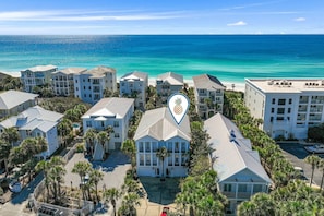 A coastal hotel complex with multiple buildings, a central staircase, and a view of the ocean. - 5BR Home w/ Pool Table in Seagrove - Steps From the Beach & Pool - Sleeps 12 (Santa Rosa Beach)