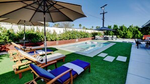 A backyard with a swimming pool, lounge chairs, and an umbrella. - Vista Ashby: Stagecoach Oasis, Pool & Mtn Views (Palm Springs)