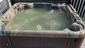 A hot tub with a wooden deck and a small step leading up to it. - COMPLETELY REMODELED-- LESS THAN A BLOCK FROM BEACH--
HOT TUB-- NOON CHECK OUT!! (BAY ST LOUIS)
