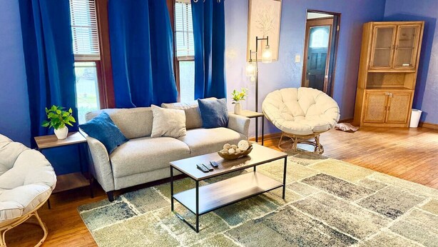 A living room with a sofa, coffee table, and a chair. - Large Group Stay Near Syracuse University & Dome (Syracuse)