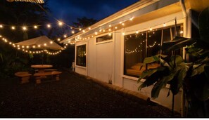 A house with string lights, a covered patio, and a window with a cushion. - Nice house with pool and terrace (El Castillo)