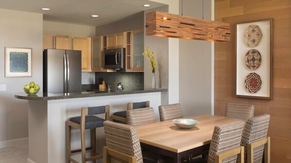A modern kitchen with wooden cabinets, stainless steel appliances, and a central island with seating. - Discover Desert Luxury at The Westin Kierland Villas - 1 Bedroom Premium Villa (Scottsdale)