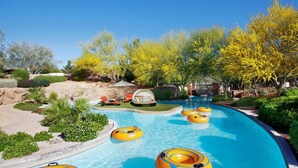A swimming pool with water slides and inflatable rings.