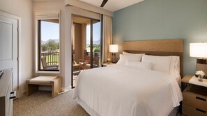 A hotel room with a large bed, a desk, a chair, and a balcony with a view of the mountains. - Discover Desert Luxury at The Westin Kierland Villas - 1 Bedroom Premium Villa (Scottsdale)