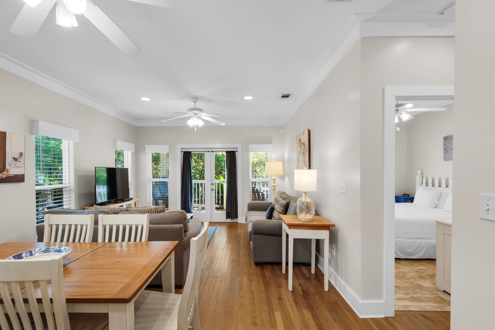 A modern interior with a dining area, living room, and bedroom.