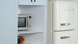 A white cabinet with a microwave and a refrigerator. - Perfect 2 Bedroom Farmhouse Close to Bulawayo CBD (Bulawayo)