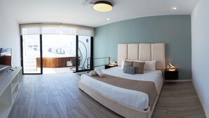 Une chambre moderne avec un grand lit, une porte vitrée donnant sur un balcon et une vue sur le paysage urbain.