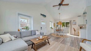 A spacious living room with a sofa, coffee table, and a ceiling fan. - 2 BR Bay Breeze Retreat (Lower Township)