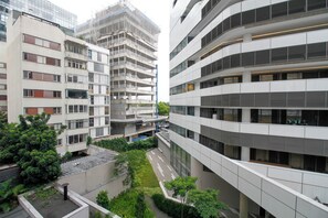 A multi-story building with a modern architectural design, featuring balconies and large windows. - Modern Studio in Pinheiros • Near Fradique Coutinho Metro (São Paulo)