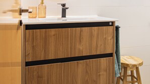 A modern bathroom with a wooden vanity, a round mirror with a light, a sink, and a stool. - Studio 2 bedrooms for climbers in ALBARRACIN | FREE WIFI (AR)
