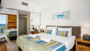 A hotel room with a bed, a desk, a chair, and a window with a view. - 1 Bedroom Balcony Poolside (Kings Beach)