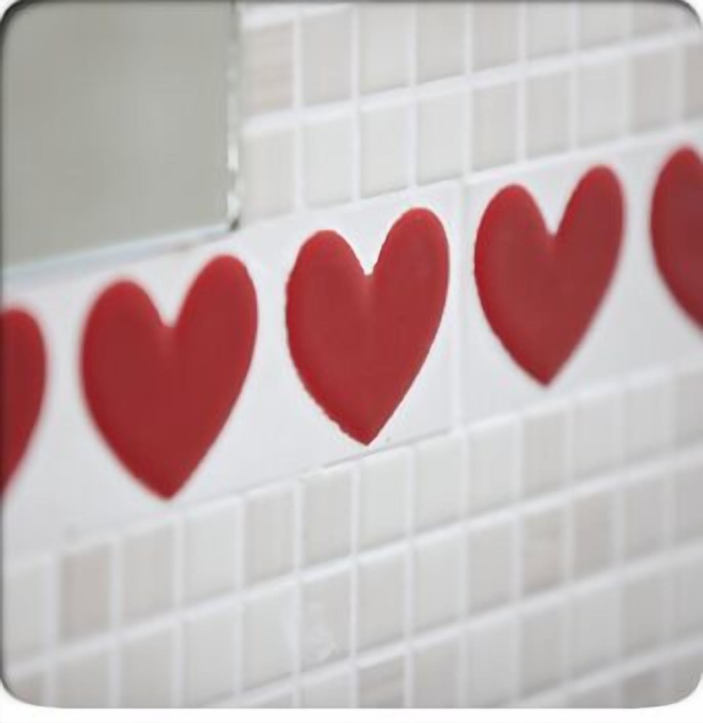 A tiled wall with heart-shaped decorations.