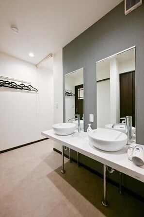 A modern bathroom with two sinks, large mirrors, and a towel rack. - Seed INN Iori (Tokyo)