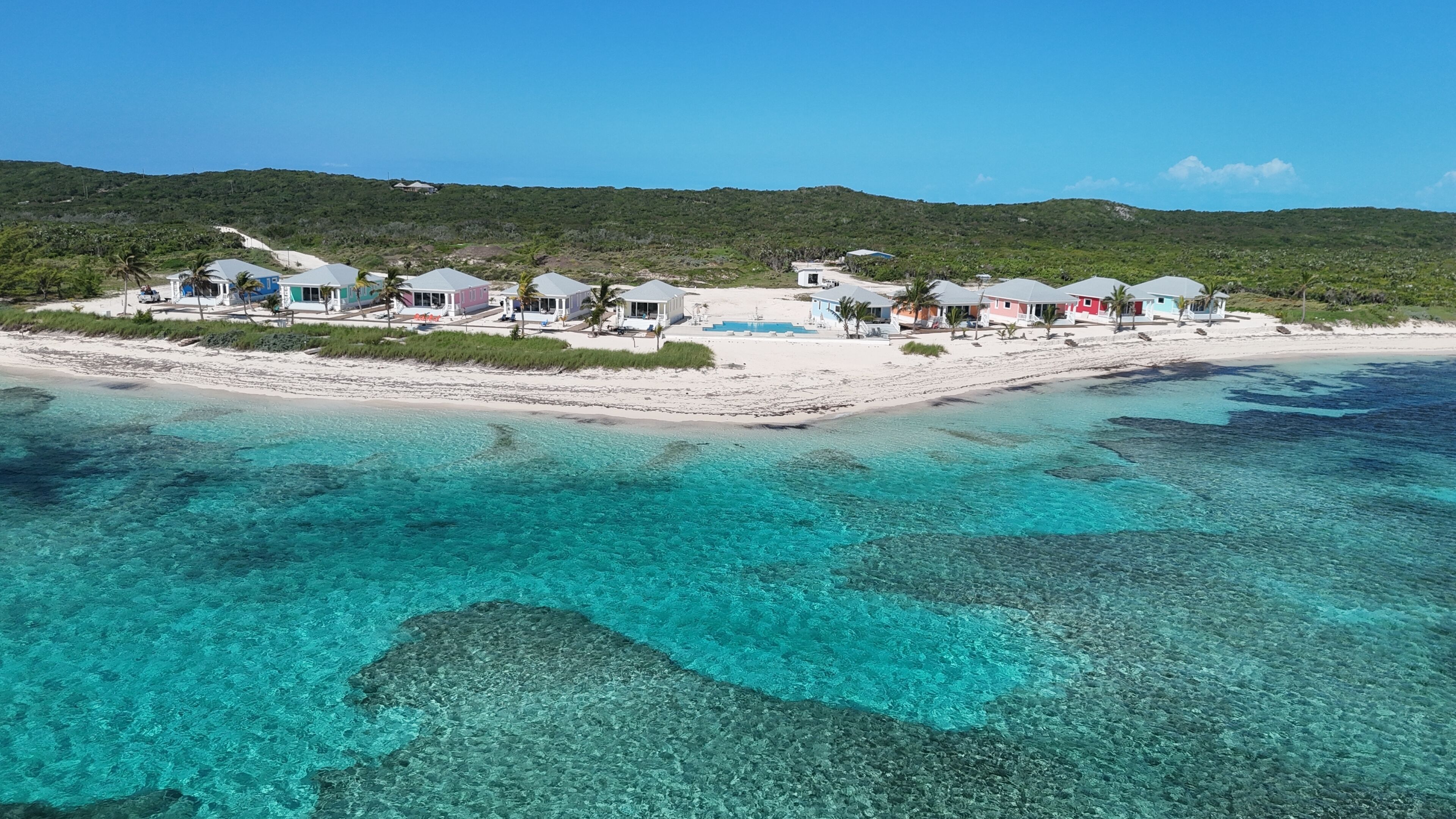 A coastal resort with clear turquoise waters, white sandy beaches, and multiple bungalow-style accommodations.
