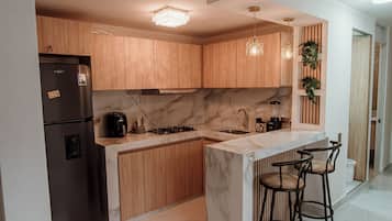 Oven, coffee/tea maker, coffee grinder, cookware/dishes/utensils