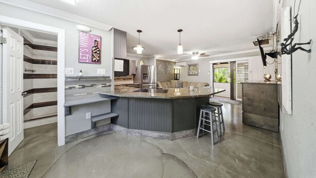 A modern kitchen with a central island, built-in appliances, and pendant lighting. - Tipsy Turtle -2 bed 3 bth Condo with Pool/ Dockage at Marina and gorgeous Gulf water views (Marathon)