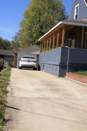 A house with a garage, a covered porch, and a driveway.