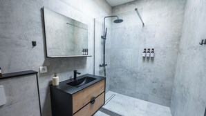 A modern bathroom with a black sink, wooden cabinet, glass shower enclosure, and a large mirror. - Cozy 3 Private Rooms Near to City Center (Ghent)