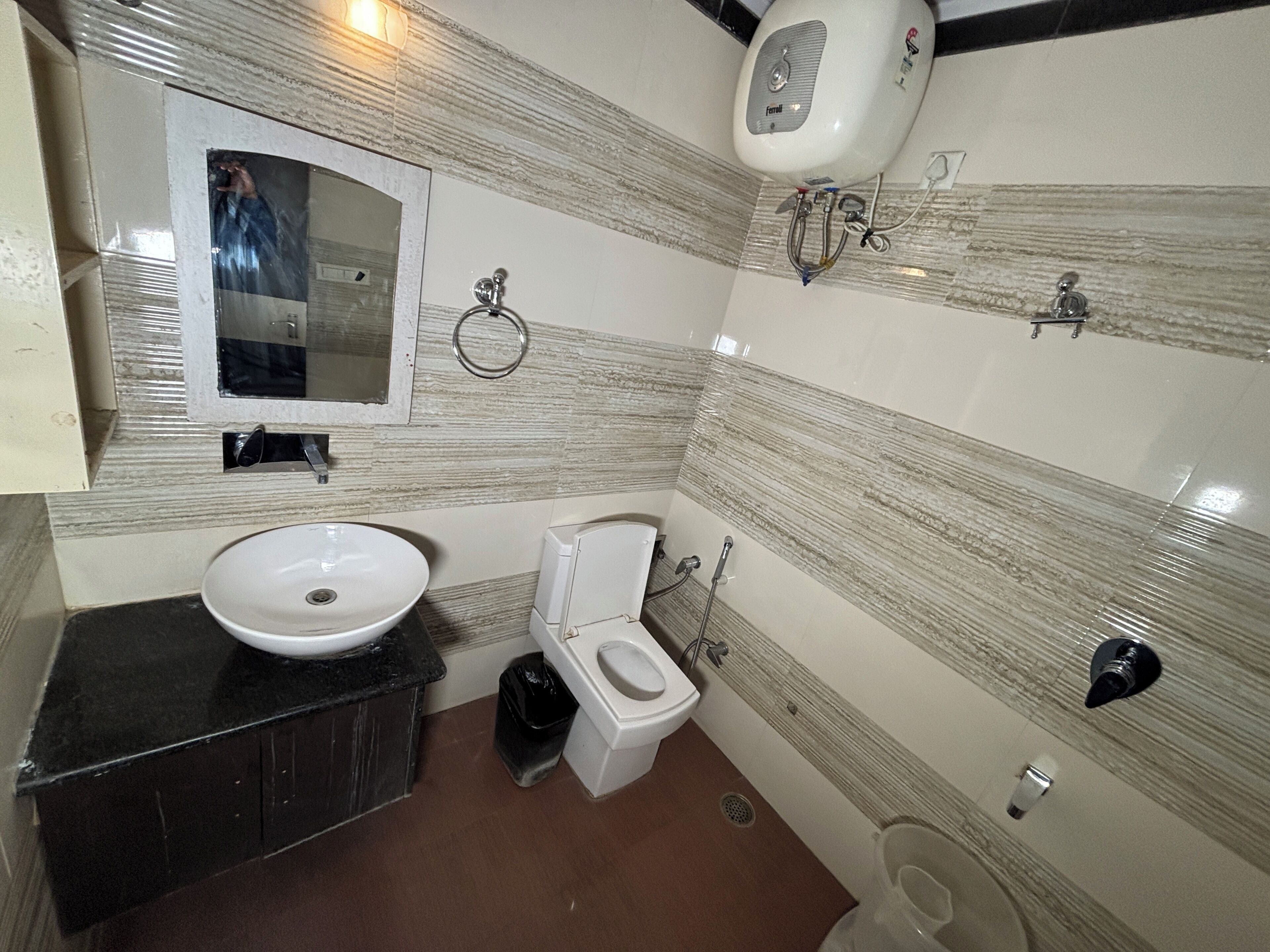 A bathroom with a sink, toilet, and mirror.