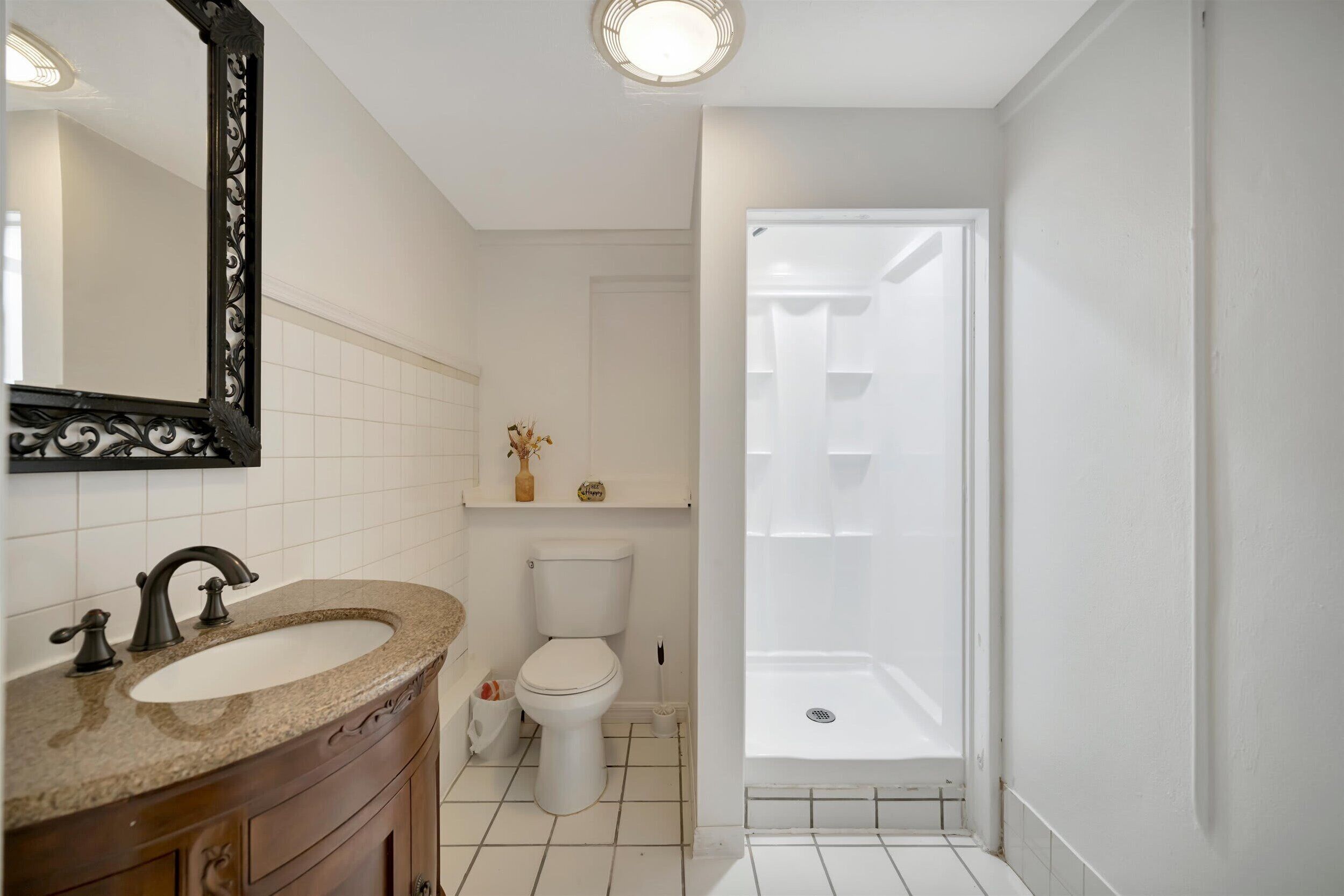 A bathroom with a sink, toilet, and shower.