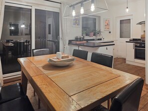 A dining area with a wooden table, chairs, and a bowl with items on it. - Gorgeous house in a great location for exploring East Kent at its finest. (Ramsgate)