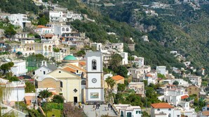 A hillside town with a prominent church, narrow streets, and residential buildings. - The Seagull - Tradewinds (Praiano)
