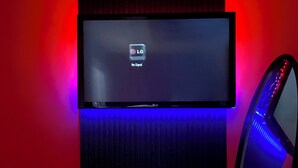A flat-screen TV mounted on a wall with a 'No Signal' message, a chair with a massage function, and LED lighting. - The private room in bungalow in Richmond Hill perfect for a relaxing getaway (Richmond Hill)