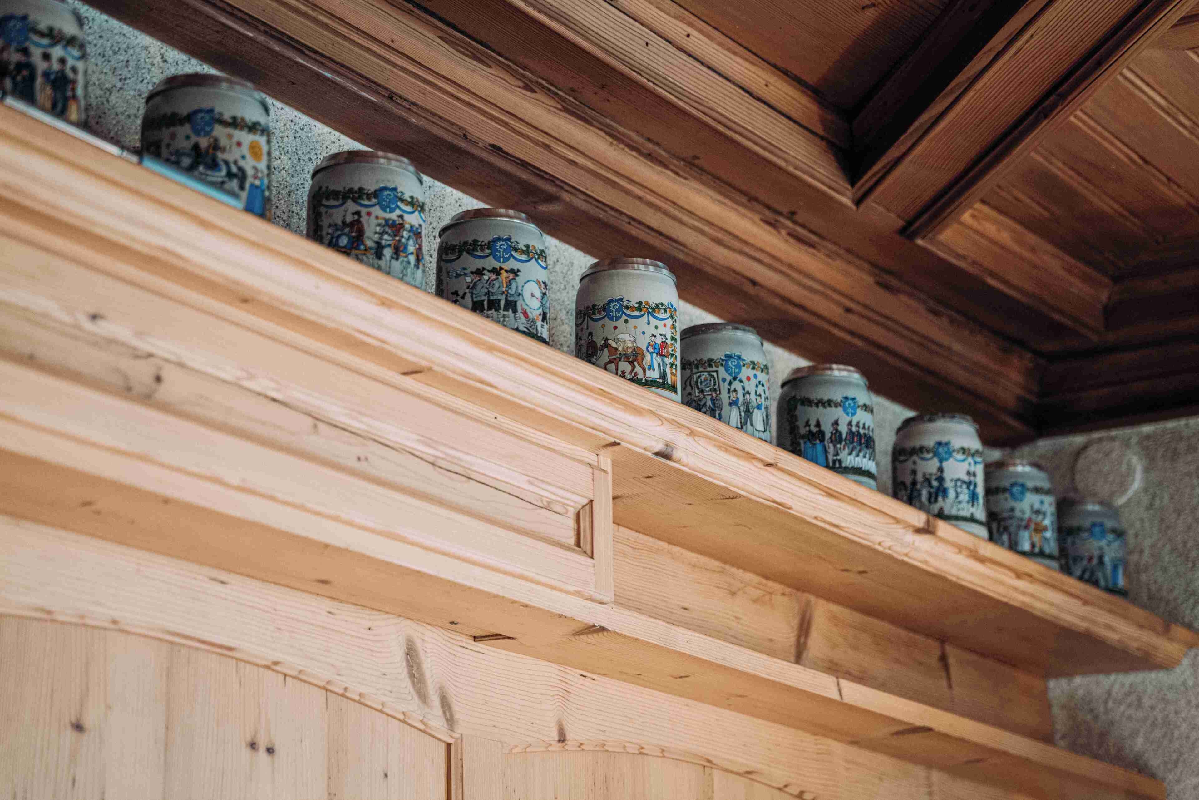 A wooden shelf with decorative jars.