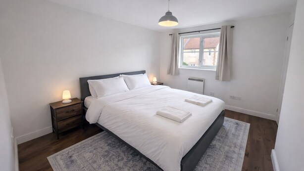A bedroom with a bed, bedside lamps, a window, and a ceiling light. - Newly Renovated 2-Bed House w/ Parking – Sleeps 5 Near Shaftesbury Town (Shaftesbury)