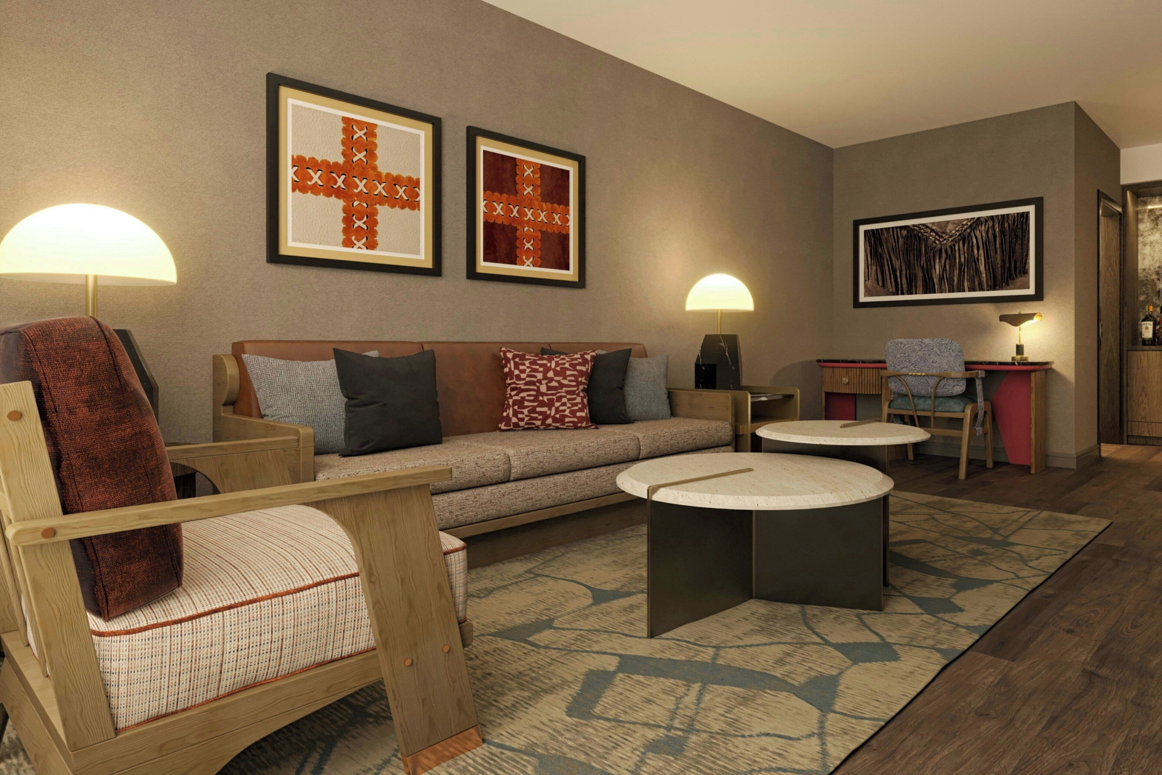 A modern living room with a sofa, armchairs, a coffee table, and a dining area.