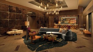 A modern living room with a sofa, coffee table, and lamp. - Hotel Trinity, Autograph Collection (Austin)