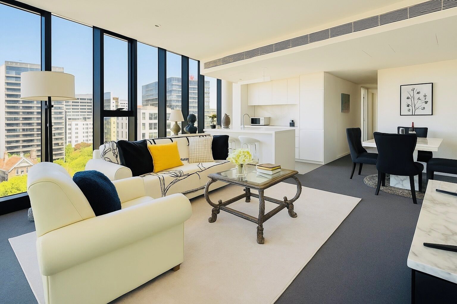 A modern living room with a sofa, coffee table, and dining area.