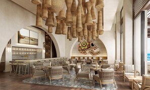 A modern interior with a bar area, seating, and a large decorative wall. - Grand Hyatt Los Cabos Resort, Golf & Spa, All-Inclusive (Cabo San Lucas)