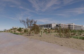 A modern building with a flat roof and rectangular windows, surrounded by a sandy area with sparse vegetation. - Grand Hyatt Los Cabos Resort, Golf & Spa, All-Inclusive (Cabo San Lucas)