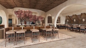 A spacious dining area with high ceilings and a central decorative tree. Tables and chairs are arranged for dining. - Grand Hyatt Los Cabos Resort, Golf & Spa, All-Inclusive (Cabo San Lucas)
