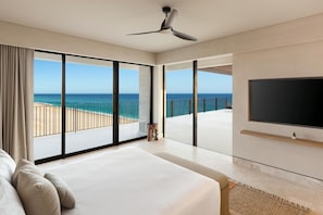 A bedroom with a large bed, a TV, and a view of the beach. - Grand Hyatt Los Cabos Resort, Golf & Spa, All-Inclusive (Cabo San Lucas)