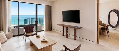 A modern hotel room with a balcony, a flat-screen TV, a dining table, and a seating area.