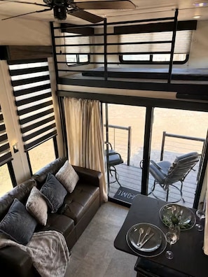 Ein flexibler Wohnbereich mit Sofa, Esstisch und Blick ins Freie.