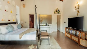 A bedroom with a bed, bedside table, and a television on a wooden stand. - ELIVAAS Maison 10 Luxe 4 BHK Villa  (Siolim)